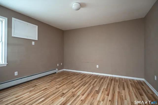 a view of room with wooden floor