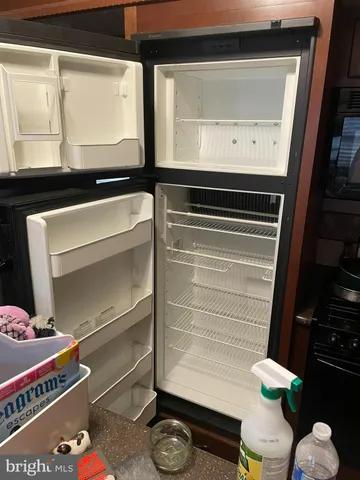 a room with gym equipment and a lamp on dresser