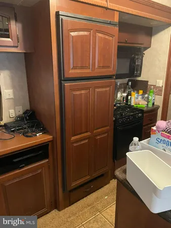 a kitchen with stainless steel appliances granite countertop a refrigerator and a stove