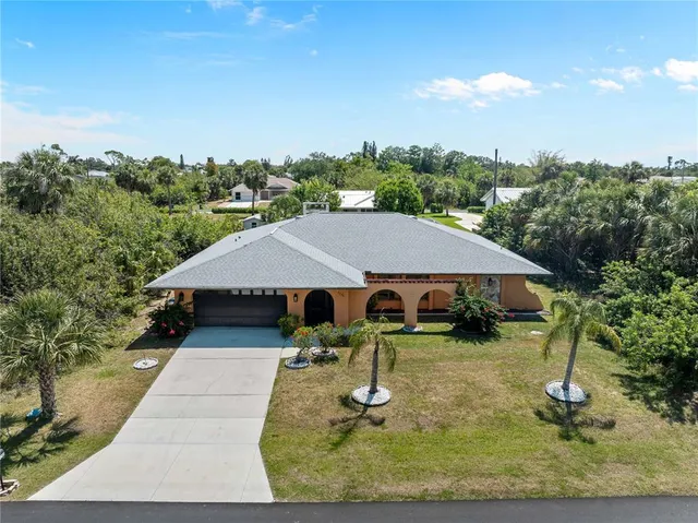 a view of a house with backyard porch and sitting area