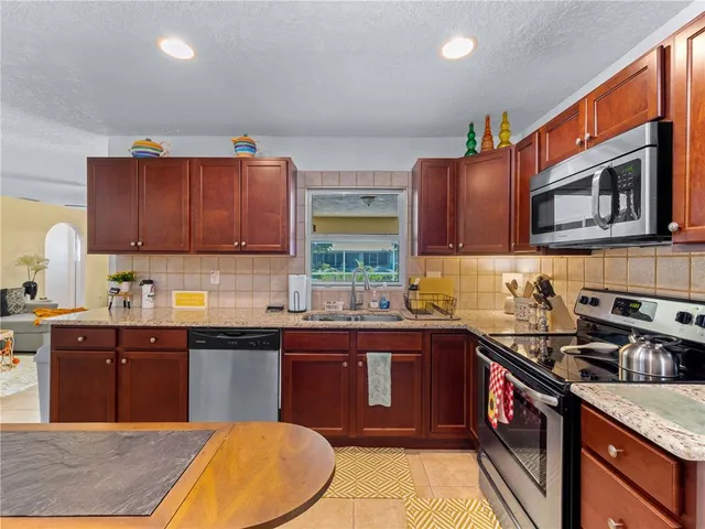 a living room with furniture ceiling fan and a rug