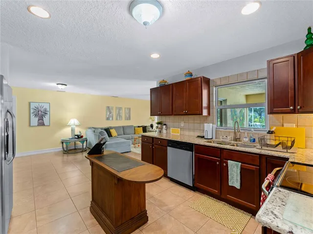 a living room with furniture ceiling fan and a window