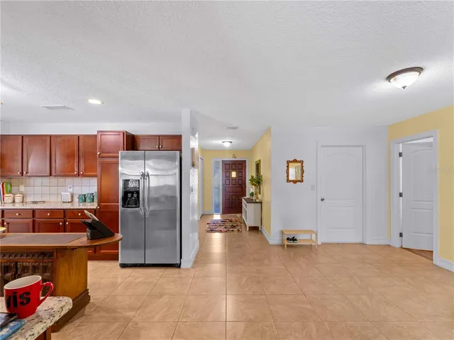 a bedroom with a bed and large windows
