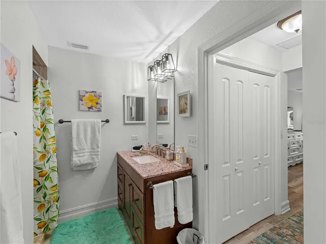 a bathroom with a double vanity sink toilet and a mirror