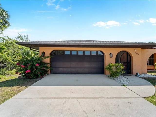 a front view of a house with plants