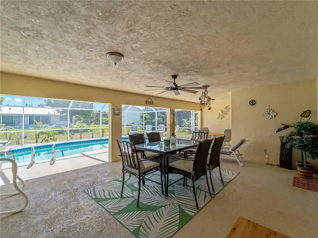 a view of a house with swimming pool and sitting area