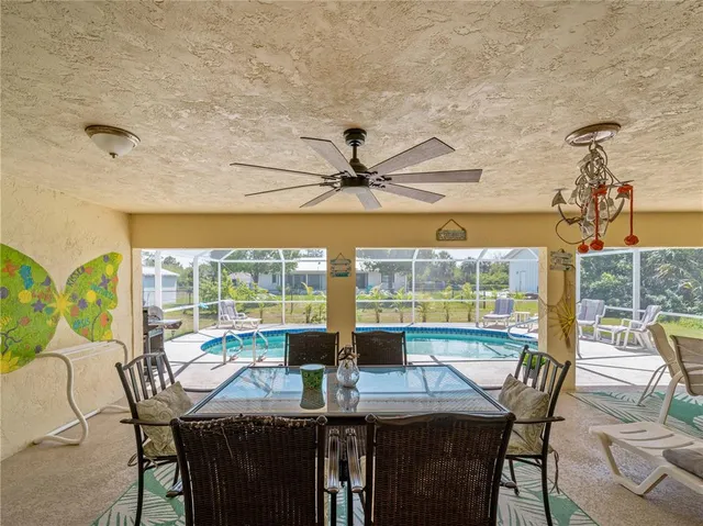 an aerial view of a house with yard and mountain view in back