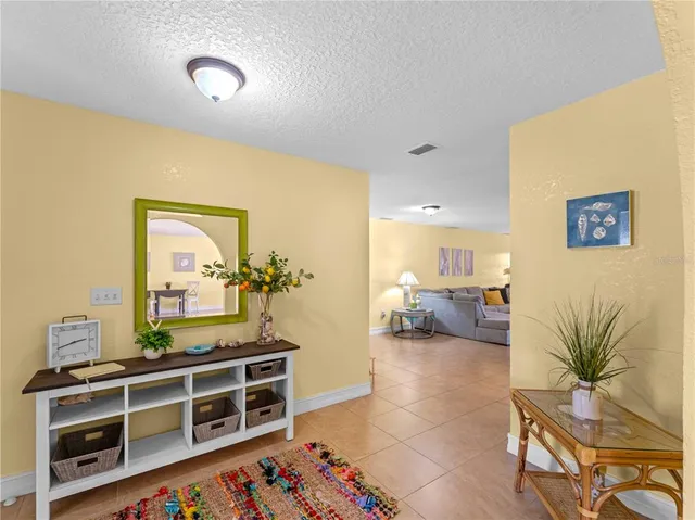 a living room with furniture a fireplace and a large window
