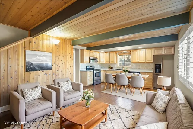 a kitchen with stainless steel appliances granite countertop a sink and cabinets with wooden floor