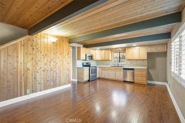 a kitchen with stainless steel appliances a stove top oven a sink and a refrigerator