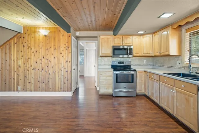 a bathroom with a granite countertop sink a mirror and a shower