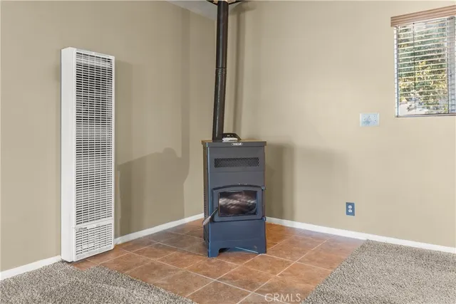 a bedroom with a bed a dresser and potted plants