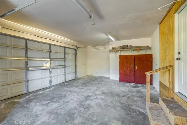 a view of a yard with plants and brick wall