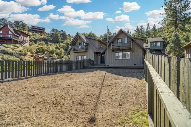 an aerial view of a house with a yard basket ball court and outdoor seating