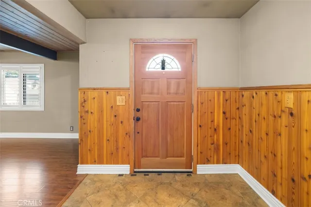 a large kitchen with cabinets and wooden floor