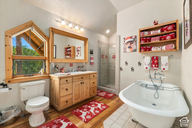 1701 Oak Road Coalville, UT 84017 - Photo 51 of 71 Wood-finish flooring, a freestanding bathtub, and a glass-enclosed shower