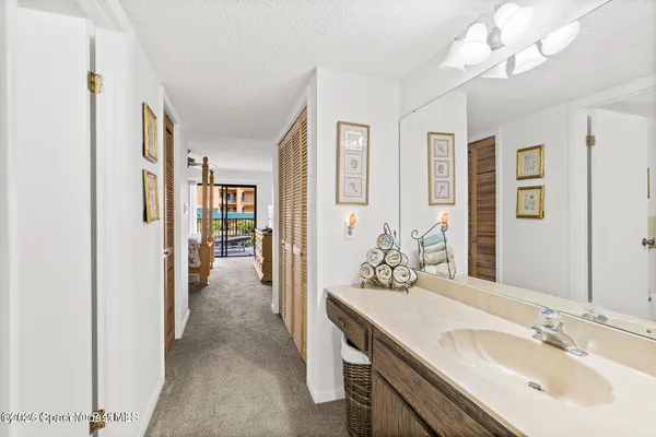 a en suite bathroom with a double vanity sink a mirror and a shower