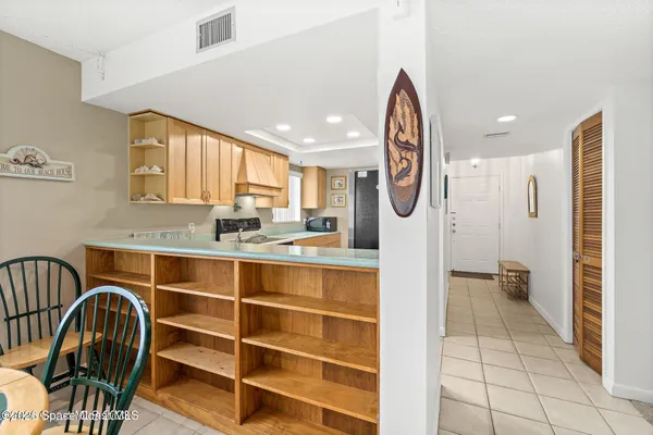 a view of kitchen with stainless steel appliances granite countertop a stove and a sink