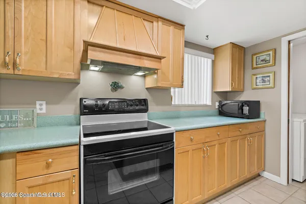 a kitchen with granite countertop a stove and a sink