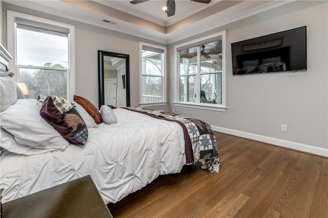 8486 Monbo Road Catawba, NC 28609 - Photo 18 of 48 a bedroom with a bed a flat screen tv and windows
