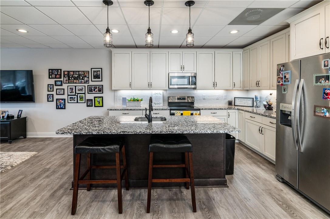 8486 Monbo Road Catawba, NC 28609 - Photo 27 of 48 a kitchen with stainless steel appliances granite countertop a sink a stove a refrigerator cabinets a dining table and chairs