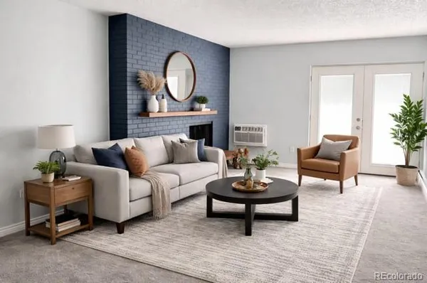 a living room with furniture a rug and a potted plant
