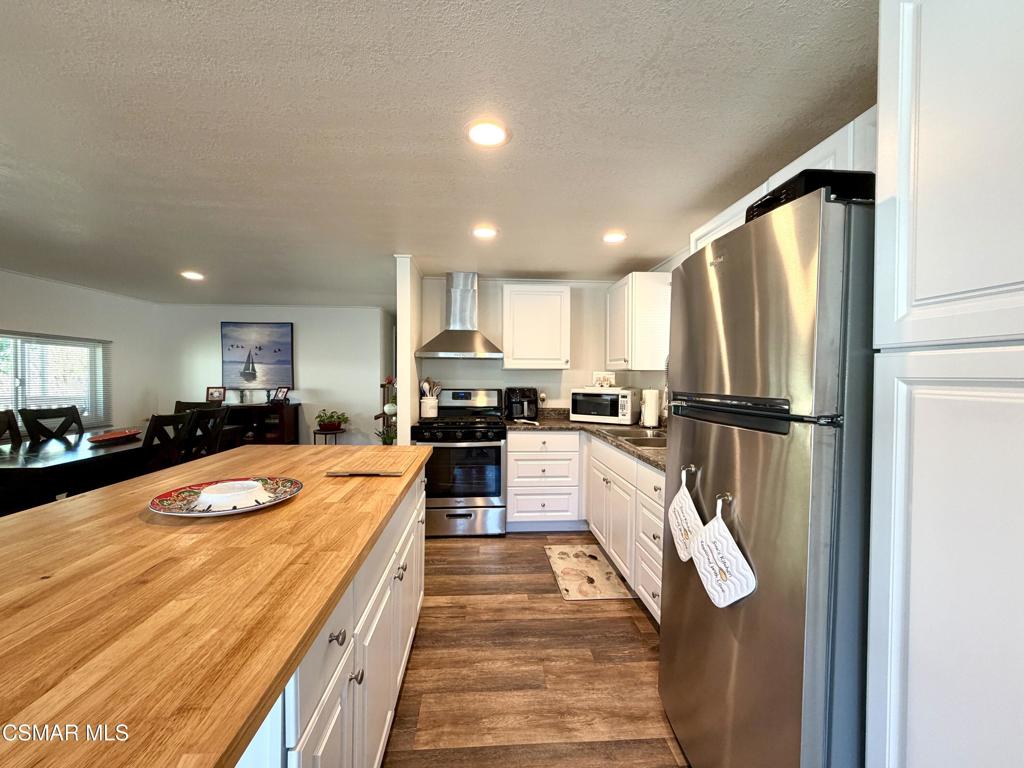 6480 Katherine Road, Unit 6 Simi Valley, CA 93063 - Photo 12 of 34 a large kitchen with stainless steel appliances lots of counter space and a refrigerator