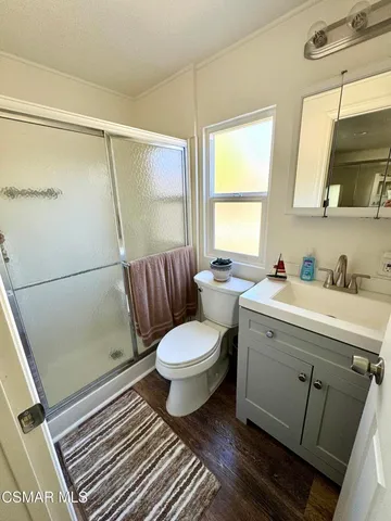 a bathroom with a sink mirror vanity and toilet
