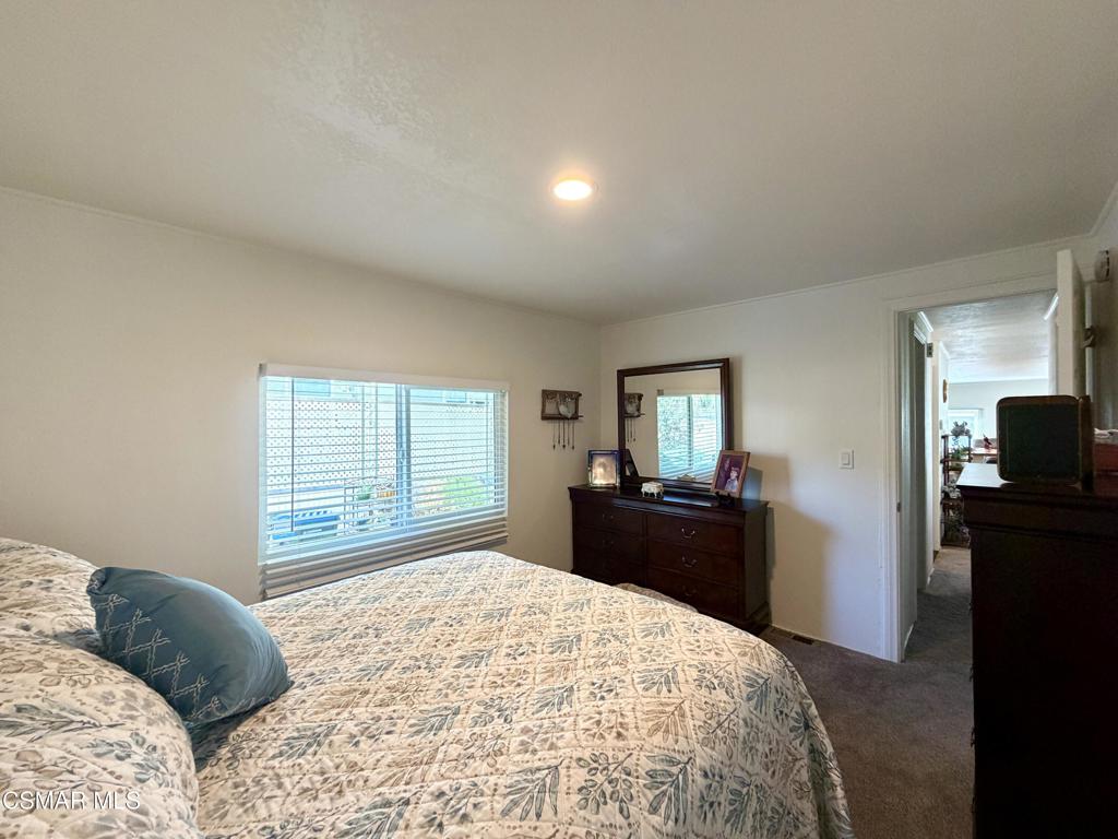 6480 Katherine Road, Unit 6 Simi Valley, CA 93063 - Photo 16 of 34 a bedroom with a bed and a dresser next to a window