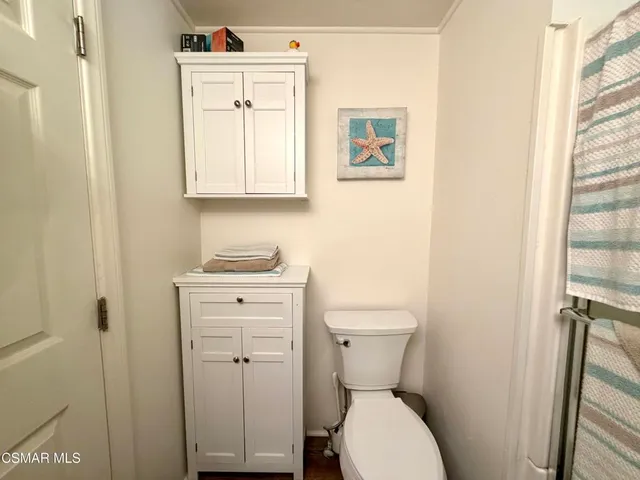 a white toilet sitting next to a bathroom sink
