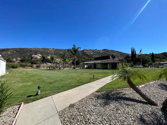 a view of a garden with a house