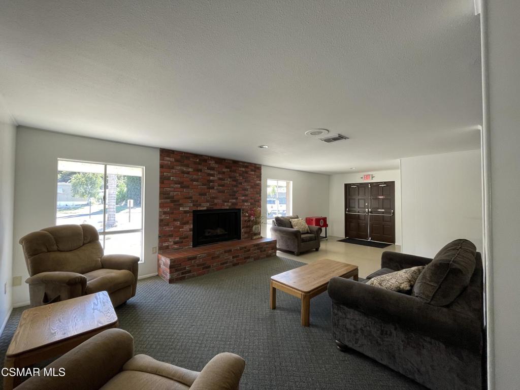 6480 Katherine Road, Unit 6 Simi Valley, CA 93063 - Photo 27 of 34 a living room with furniture a fireplace and a flat screen tv