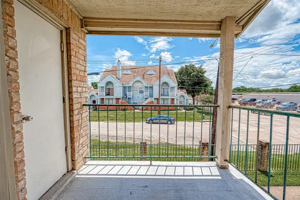 a view of a house with a small yard and a floor to ceiling window