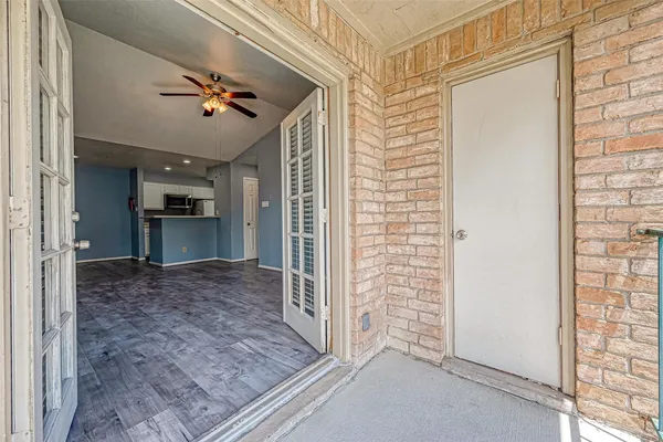 an empty room with windows and fireplace
