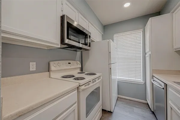 a kitchen with a stove and a microwave