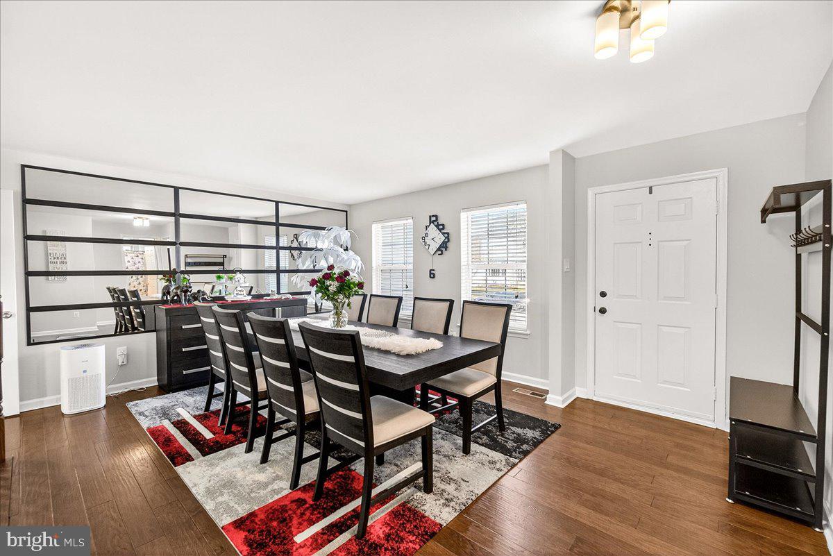 6303 Edgeware Court Frederick, MD 21703 - Photo 10 of 74 a view of a dining room with furniture and wooden floor