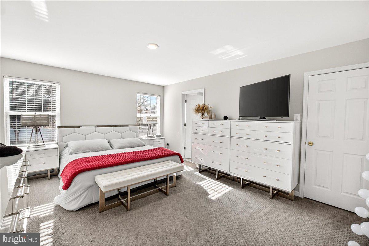 6303 Edgeware Court Frederick, MD 21703 - Photo 28 of 74 a bedroom with a bed and flat screen tv