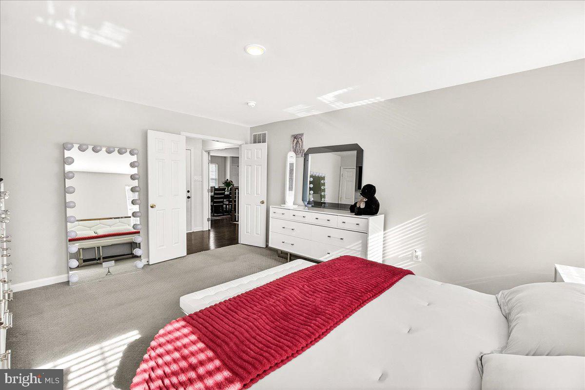6303 Edgeware Court Frederick, MD 21703 - Photo 29 of 74 a living room with a bed furniture and a flat screen tv