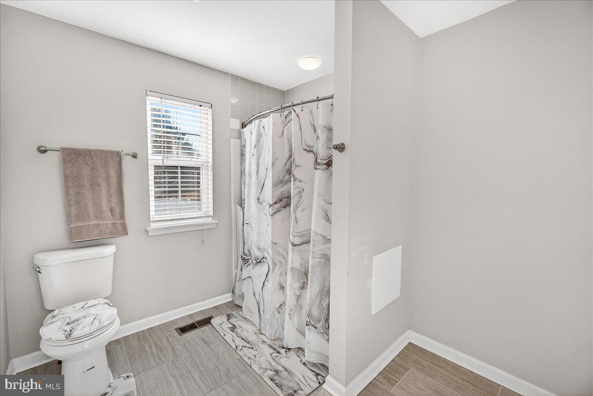 6303 Edgeware Court Frederick, MD 21703 - Photo 31 of 74 a bathroom with a toilet and a shower