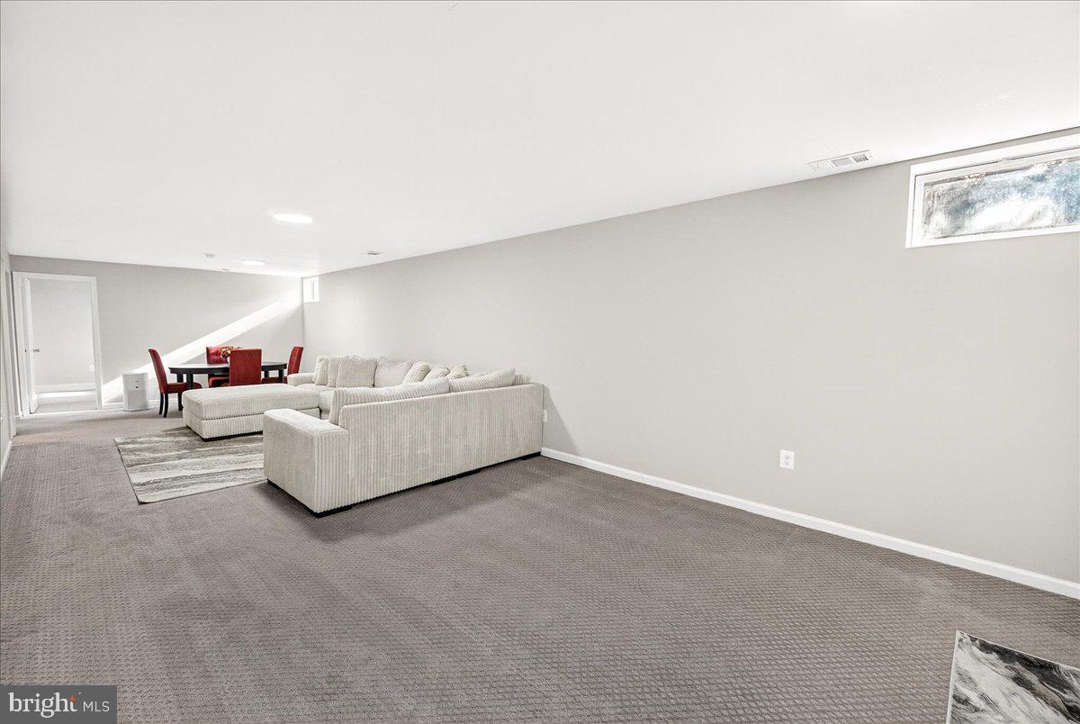 6303 Edgeware Court Frederick, MD 21703 - Photo 39 of 74 a spacious bedroom with a bed and a couch