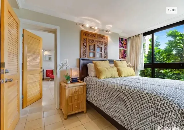 a bed room with a bed and glass window