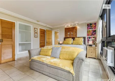 a bedroom with furniture and a flat screen tv