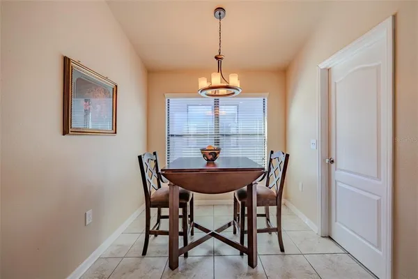a view of a dining room with a table and chairs