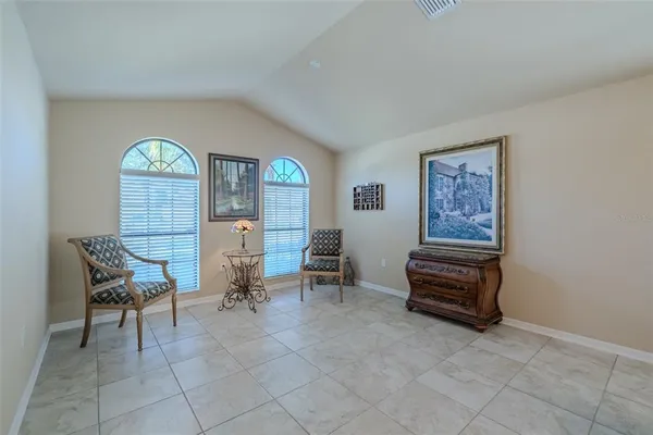 a living room with furniture a piano and a window