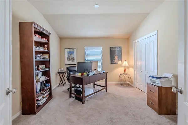 a living room with furniture and a book shelf