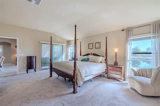 a bedroom with a bed lamps and fireplace