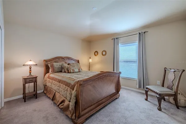 a bedroom with a bed and a chair