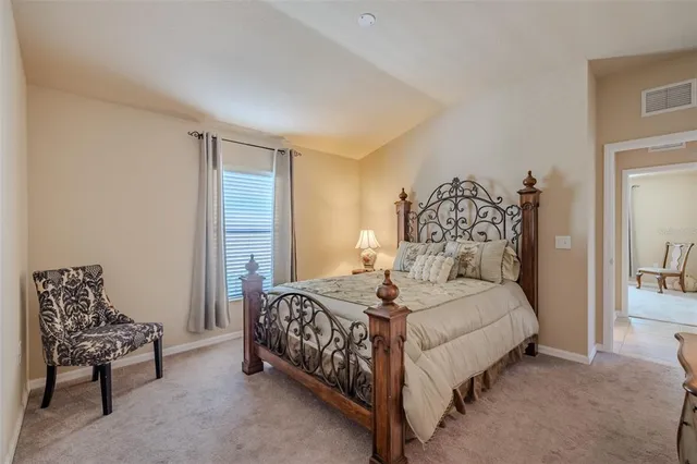 a bedroom with a bed and a couch