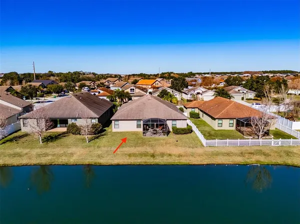an aerial view of residential houses with outdoor space and swimming pool