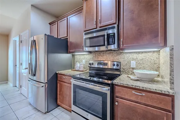 a kitchen with stainless steel appliances granite countertop a refrigerator stove and microwave